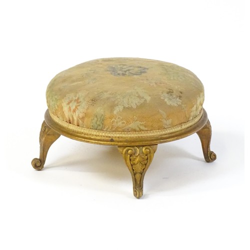 151 - An early 20thC circular footstool raised on four acanthus carved cabriole legs. 12