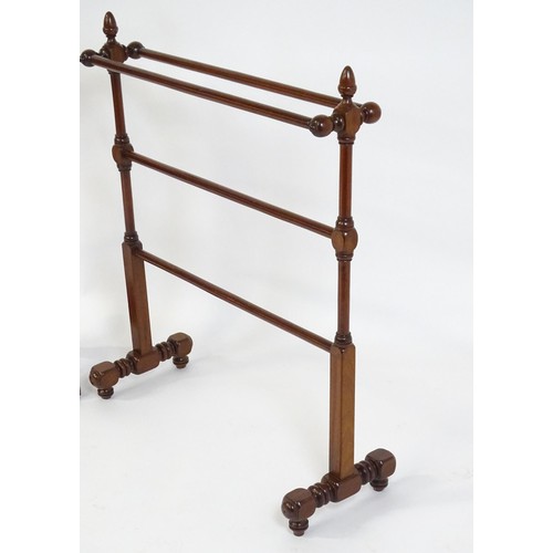 252 - Two 20thC mahogany towel rails. The largest measuring 27