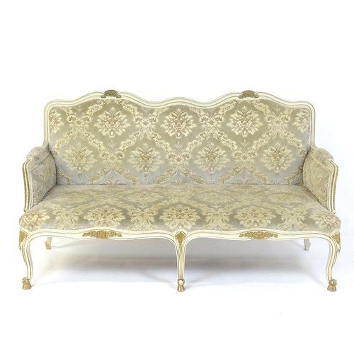 A 20thC Louis XV style sofa with carved flower and shell decoration raised on five cabriole legs. 61" wide.