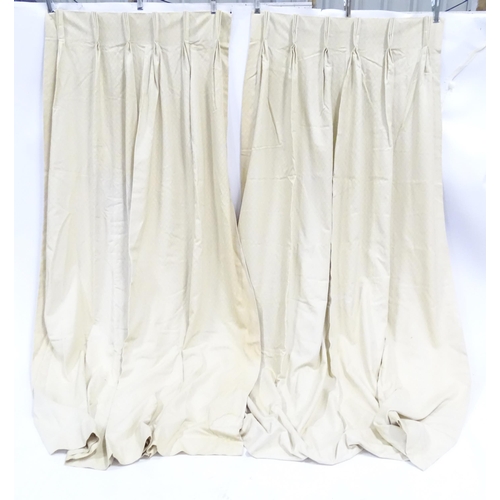 21 - A pair of curtains with a cream ground with lozenge detail. Approx. 45