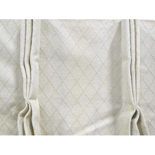 21 - A pair of curtains with a cream ground with lozenge detail. Approx. 45