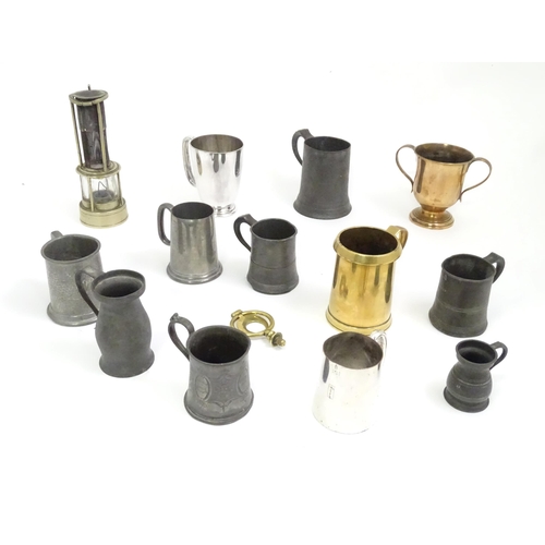 449 - A quantity of metalware, comprising pewter and brass tankards, a heavy horse terrett and miners lamp... 