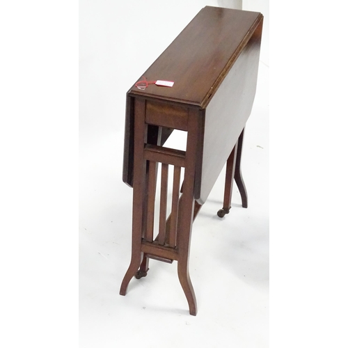 585 - An early 20thC mahogany drop flap / Sutherland table with canted corners, together with a 19thC leat... 