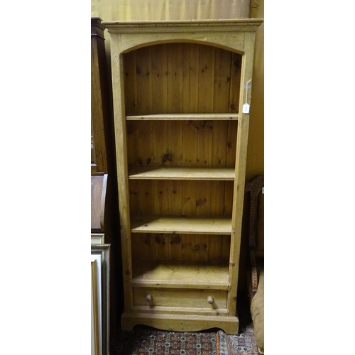 82 - A modern stripped pine four-tier bookcase with single lower drawer, standing 71