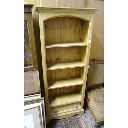 82 - A modern stripped pine four-tier bookcase with single lower drawer, standing 71