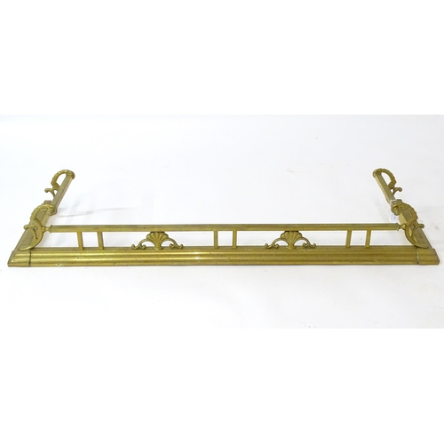 539 - A brass fire fender with scrolling supports,  approx 53 1/2