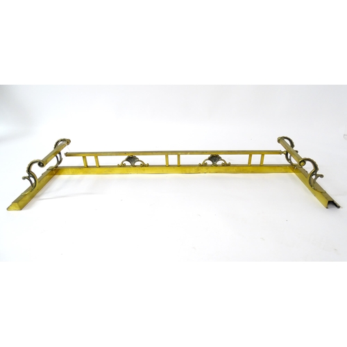 539 - A brass fire fender with scrolling supports,  approx 53 1/2