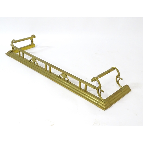 539 - A brass fire fender with scrolling supports,  approx 53 1/2