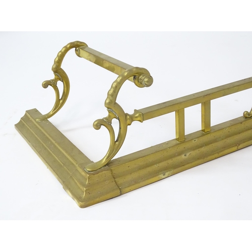 539 - A brass fire fender with scrolling supports,  approx 53 1/2