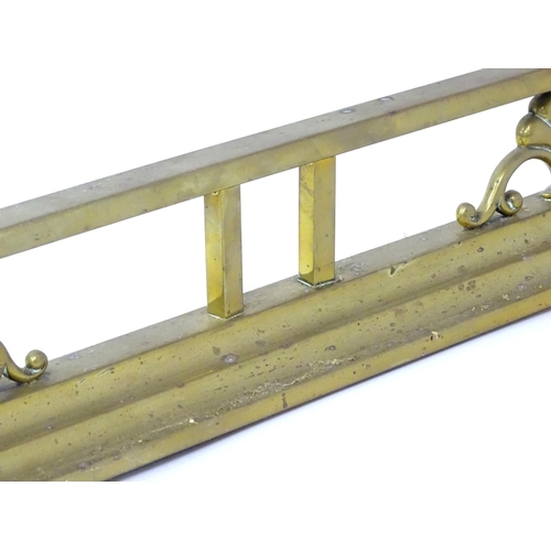 539 - A brass fire fender with scrolling supports,  approx 53 1/2