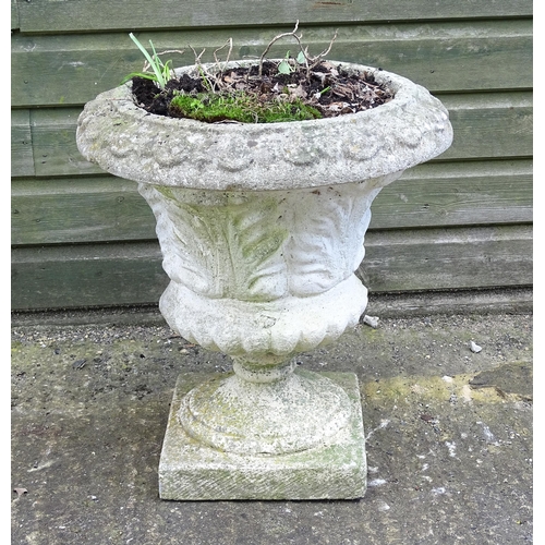 921 - A reconstituted stone planter of classical urn form, standing approx 20