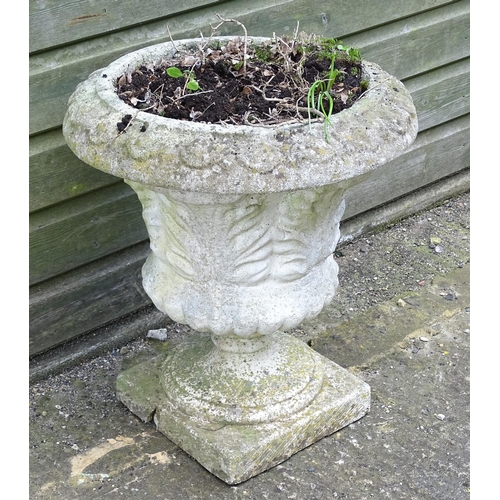 921 - A reconstituted stone planter of classical urn form, standing approx 20