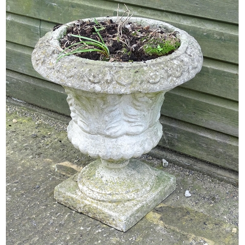 921 - A reconstituted stone planter of classical urn form, standing approx 20