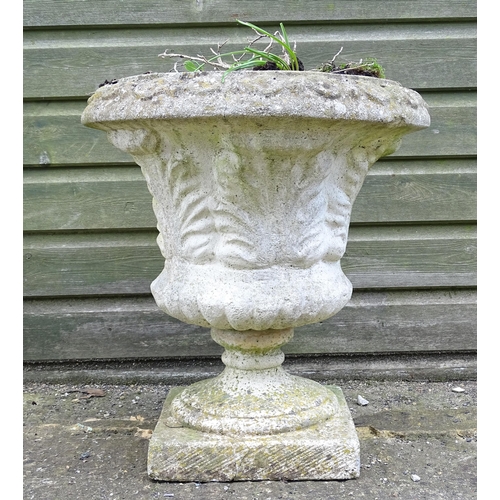 921 - A reconstituted stone planter of classical urn form, standing approx 20