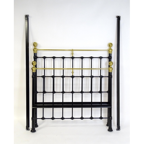 928 - A 20thC black painted double bed with gilt highlights. Approx 82