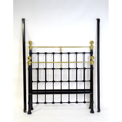 928 - A 20thC black painted double bed with gilt highlights. Approx 82