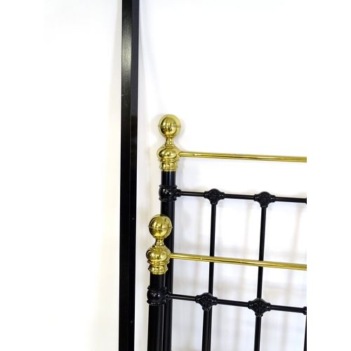 928 - A 20thC black painted double bed with gilt highlights. Approx 82