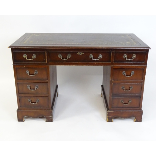 929 - A modern double pedestal writing desk with a gold tooled leather top. 48