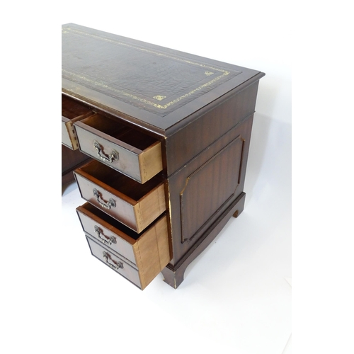 929 - A modern double pedestal writing desk with a gold tooled leather top. 48