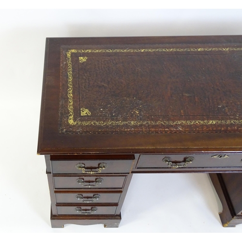 929 - A modern double pedestal writing desk with a gold tooled leather top. 48