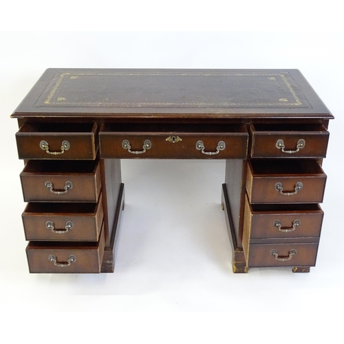 929 - A modern double pedestal writing desk with a gold tooled leather top. 48