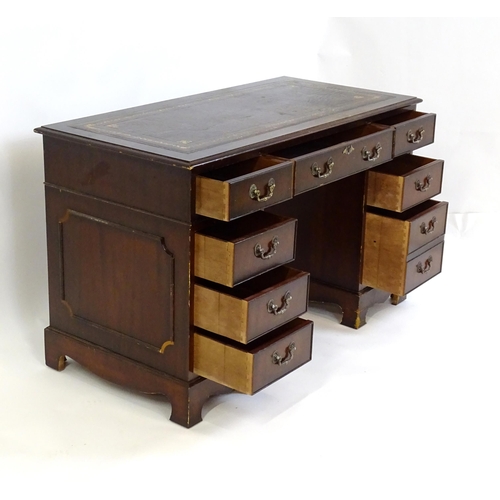 929 - A modern double pedestal writing desk with a gold tooled leather top. 48