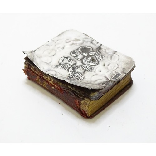 410 - A miniature prayer book with silver front cover with embossed angel detail. hallmarked Birmingham 19... 