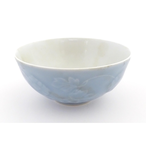 28 - A Chinese bowl with a blue ground decorated with flowers and petals. Character marks under. Approx. ... 