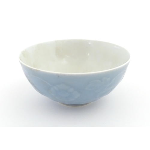 28 - A Chinese bowl with a blue ground decorated with flowers and petals. Character marks under. Approx. ... 