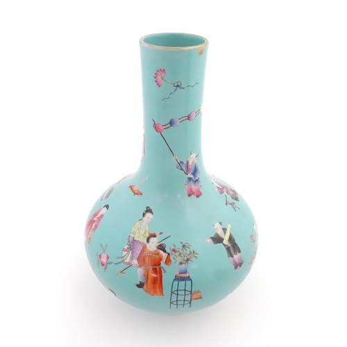 29 - A Chinese famille rose vase with a turquoise ground decorated with figures and auspicious symbols. C... 