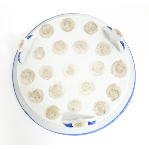 39 - A Chinese blue and white stand of circular form raised on three feet decorated with prunus flowers. ... 