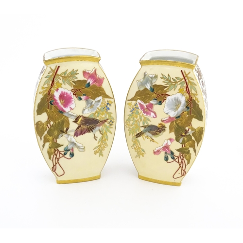 76 - A pair of Limoges Demartial and Tallandier vases of ovoid form decorated with exotic birds, flowers ... 