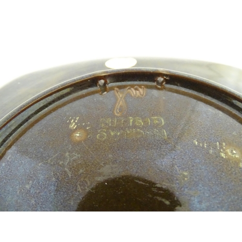 105 - A Scandinavian Ruska brown stoneware charger, marked under Arabia Finland. Together with a Swedish N... 