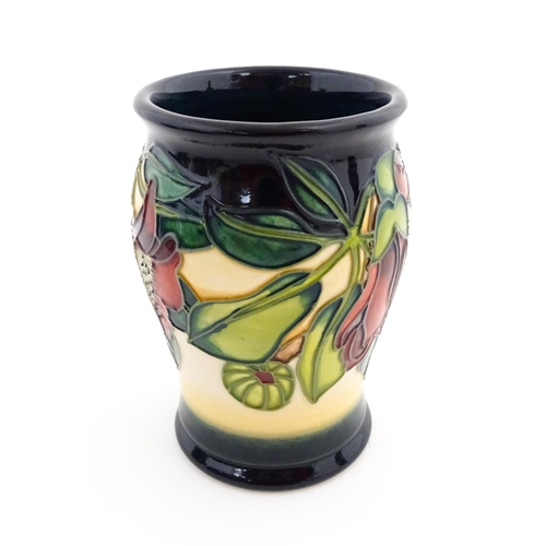 132 - A Moorcroft vase of barrel form decorated in the Kapok Tree. Marked and signed under. Approx. 5 1/2