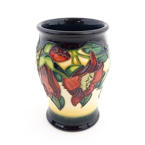 132 - A Moorcroft vase of barrel form decorated in the Kapok Tree. Marked and signed under. Approx. 5 1/2