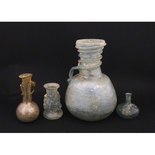 185 - Four glass vases in the Roman style with iridescent finish, some with trail detail. Largest approx. ... 