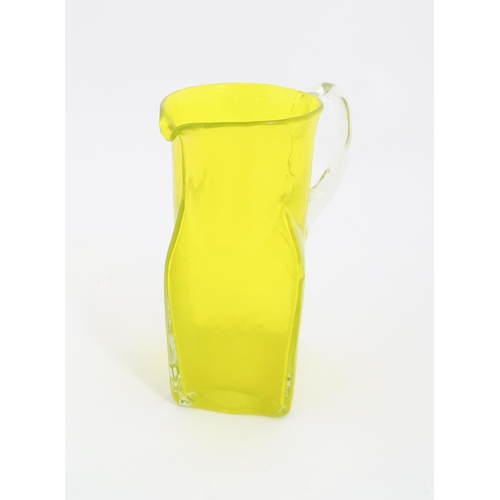 192 - A 20thC yellow glass jug with squared base and clear glass handle. Approx. 8 1/2