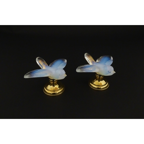 194 - A pair of glass models of swallows raised on French silver gilt stands, stamped Odiot. Approx. 2 1/4... 