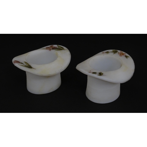 224 - A pair of milk glass match holders / vesta keeps  formed as top hats with hand painted floral detail... 