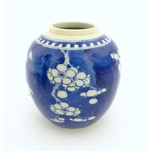 13 - A Chinese blue and white jar decorated with prunus blossom. Character marks under. Approx. 5