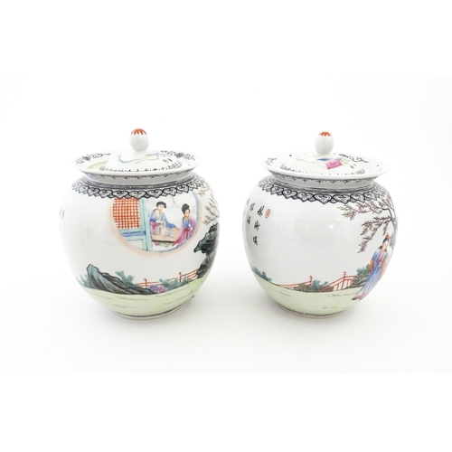 32 - A pair of Chinese pot and cover vases decorated with ladies in a landscapes, and Character script. C... 