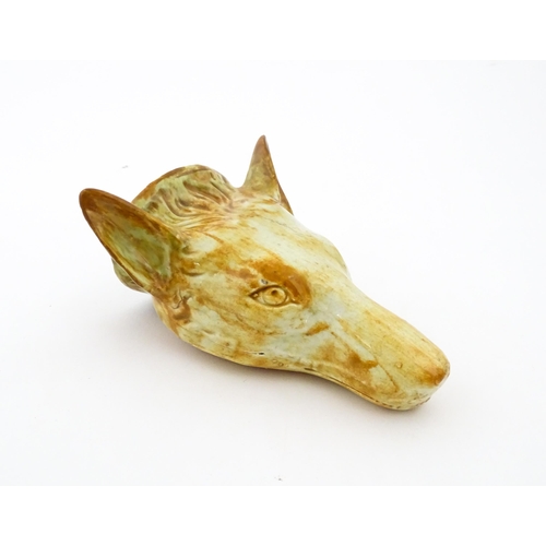 65 - A creamware stirrup cup formed as a fox head, in the manner of Whieldon. Approx. 4 3/4