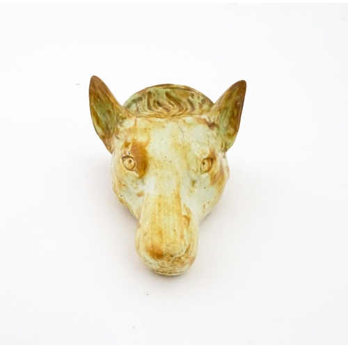 65 - A creamware stirrup cup formed as a fox head, in the manner of Whieldon. Approx. 4 3/4