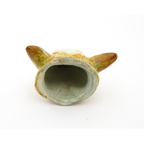 65 - A creamware stirrup cup formed as a fox head, in the manner of Whieldon. Approx. 4 3/4