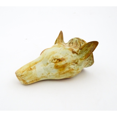 65 - A creamware stirrup cup formed as a fox head, in the manner of Whieldon. Approx. 4 3/4