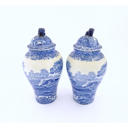 74 - A pair of Copeland blue and white lidded vases decorated in Spode's Italian pattern depicting figure... 