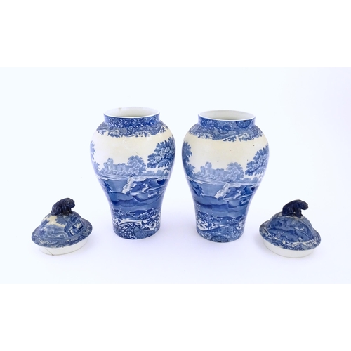 74 - A pair of Copeland blue and white lidded vases decorated in Spode's Italian pattern depicting figure... 