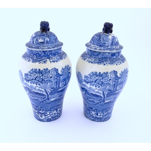 74 - A pair of Copeland blue and white lidded vases decorated in Spode's Italian pattern depicting figure... 