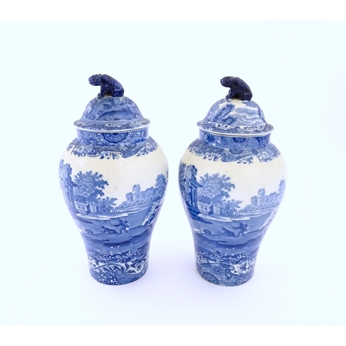 74 - A pair of Copeland blue and white lidded vases decorated in Spode's Italian pattern depicting figure... 