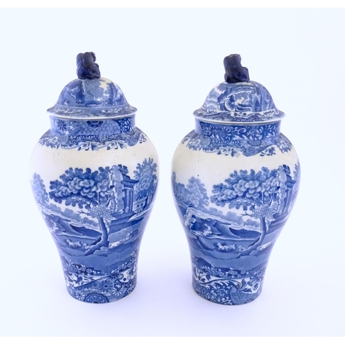 74 - A pair of Copeland blue and white lidded vases decorated in Spode's Italian pattern depicting figure... 